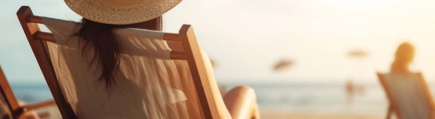 Woman sitting on a deckchair at the beach