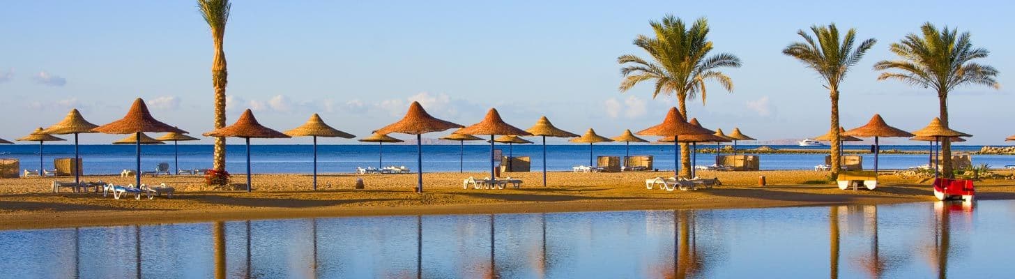Palm trees & umbrellas on the beach in Hurghada