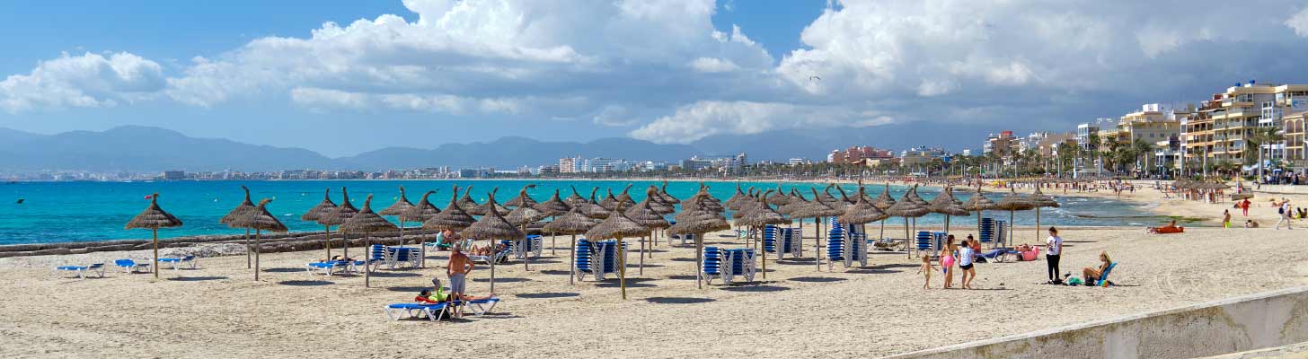 Sun umbrellas & loungers on the sandy beach of El Arenal, Majorca