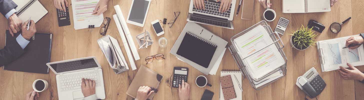 Laptops and other work items on a shared office desk