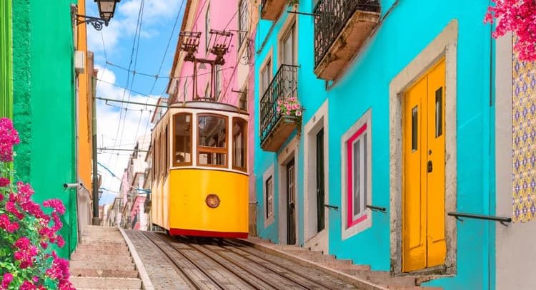 Tram & colourful houses in street in Lisbon