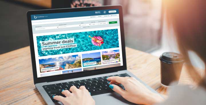 Woman looking at a travel website on her laptop