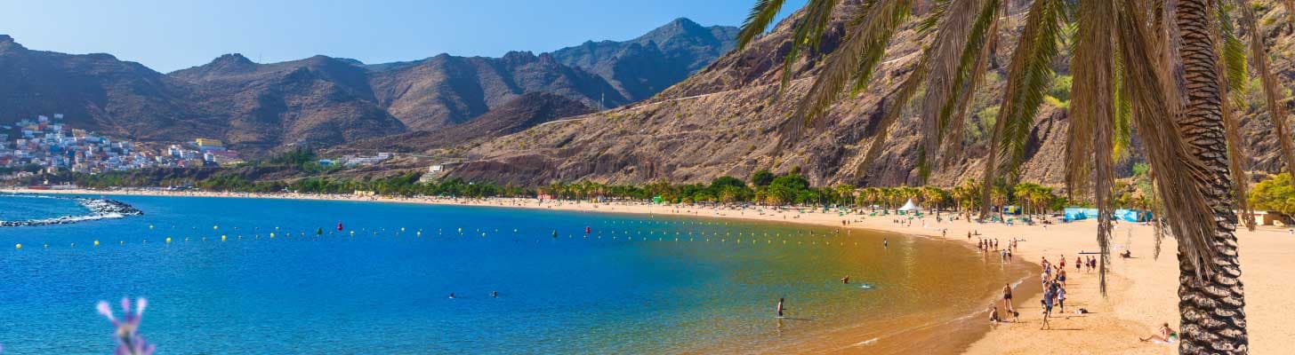 Golden sands & blue waters of a beach in Tenerife