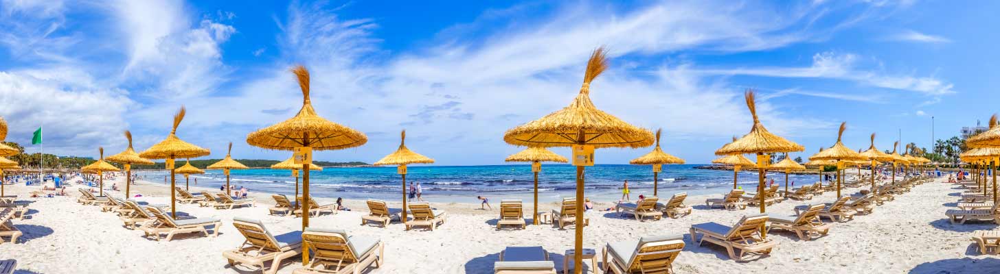 Sun loungers & umbrellas on Sa Coma beach, Majorca