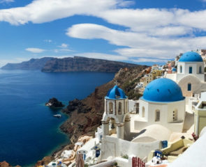 Oia in Santorini and its blue-domed churches and Mediterranean sea views