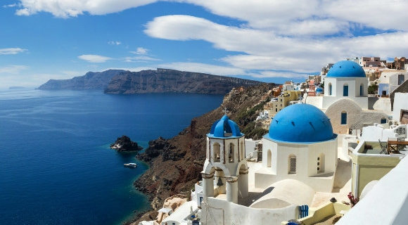 Oia in Santorini and its blue-domed churches and Mediterranean sea views