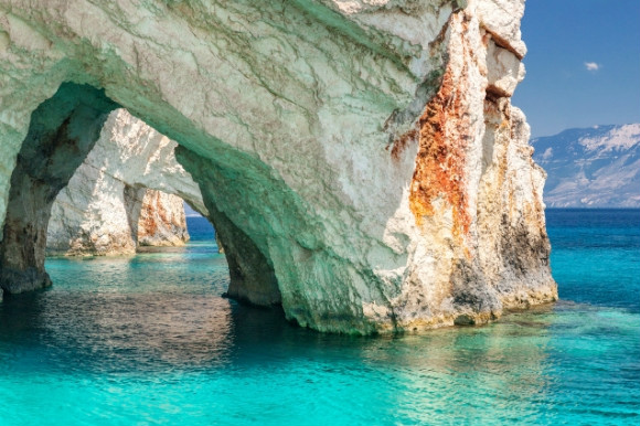 Shimmering blue waters surrounding the Blue Caves of Zante in Greece.