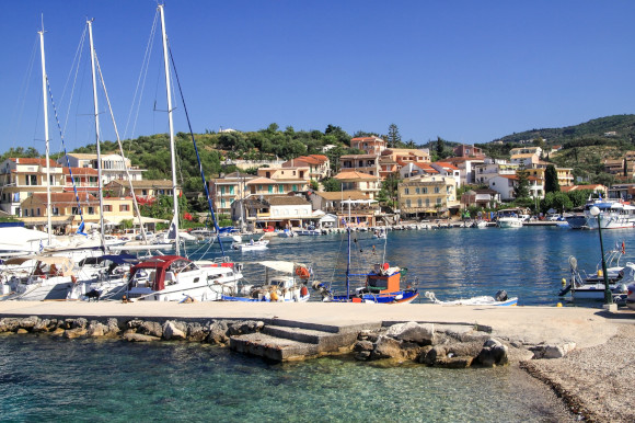 The scenic village of Kassiopi and it's idyllic harbour lined with fishing boats and backed by traditional houses