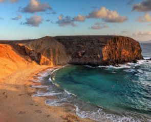 The lunar landscape of Papagayo Beach in Lanzarote and its sapphire waters.