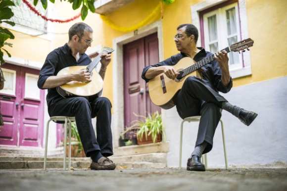 Two Fado guitarists on the streets of Portugal entertaining tourists and locals