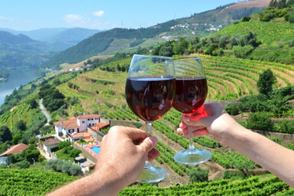 Wine glasses pushed together overlooking the striking Douro Valley in Portugal