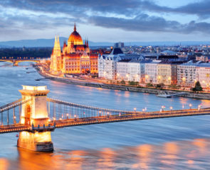 Budapest at night with chain bridge and parliament building overlooking the river side
