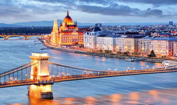 Budapest at night with chain bridge and parliament building overlooking the river side