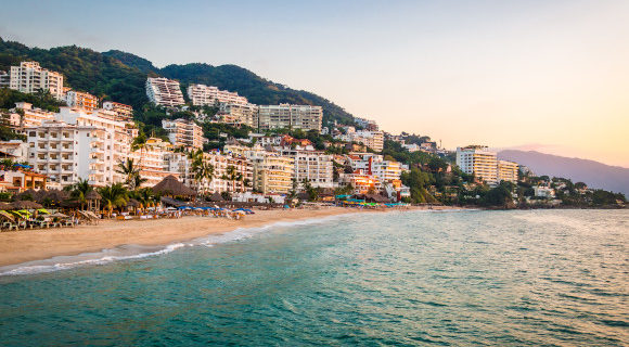 The beautiful resort of Puerto Vallarta in Mexico as the sunsets along the coastline and hotel strip