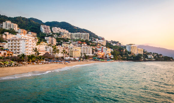 The beautiful resort of Puerto Vallarta in Mexico as the sunsets along the coastline and hotel strip