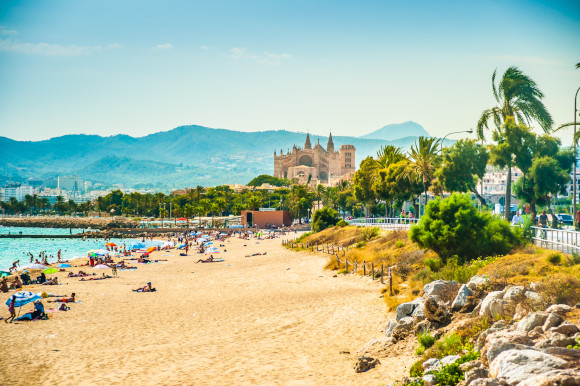 A beautiful beach in the city of Palma on the island of Majorca backed by a hilly landscape