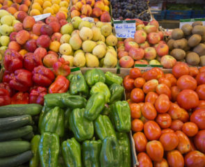 A fruit and vegetable stall in the Algarve region of Portugal containing apples, peppers and cucumbers