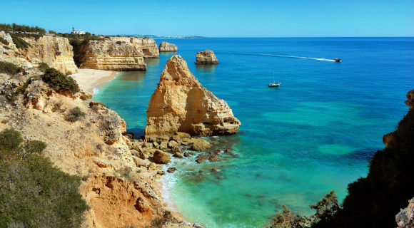The famous Praia da Marinha Beach in Portugal with limestone cliffs sitting among beautiful, azure waters