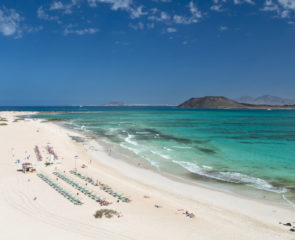 Corralejo Beach on the Canary Island Fuerteventura with a wide body of white sand and clear turquoise waters