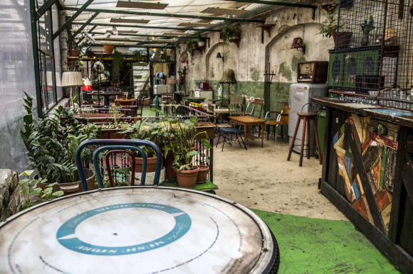 A ruin bar in Budapest filled with empty tables and plants