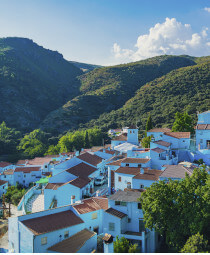 Sky blue buildings with a backdrop of green rolling hills