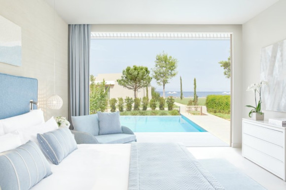 Featuring the bed and swim-up suite in the deluxe rooms at Ikos Dassia Greece