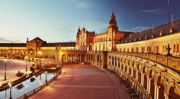 Plaza de Espana lit up at night in the Spanish city of Seville