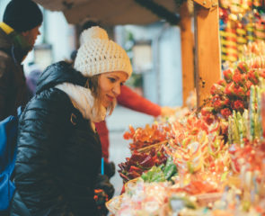 A woman shopping for gifts at a Christmas market