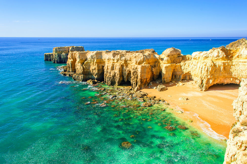 beautiful sea view with secret sandy beach among rocks and cliffs near Albufeira in Algarve, Portugal