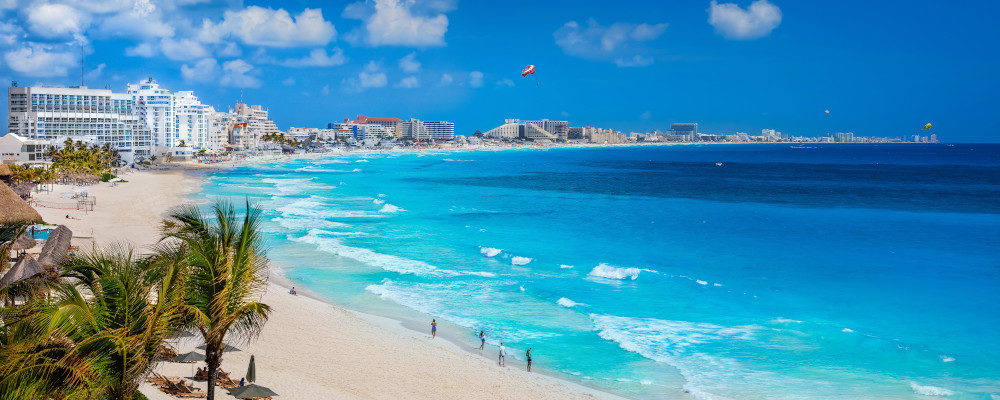 Cancun's skyline overlooking the glistening Caribbean sea with hotel's fronted by the whitest sands