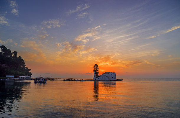 View of a lighthouse at sunset in Corfu, Greece.