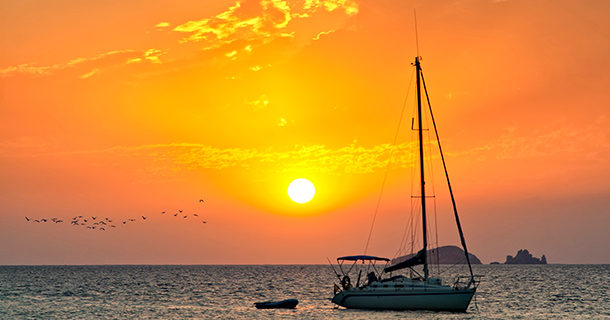 Orange sunset with boat in San Antonio, Ibiza