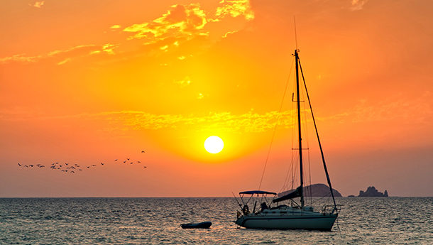 Orange sunset with boat in San Antonio, Ibiza