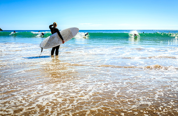 Surfers surfing in Sagres, Algarve