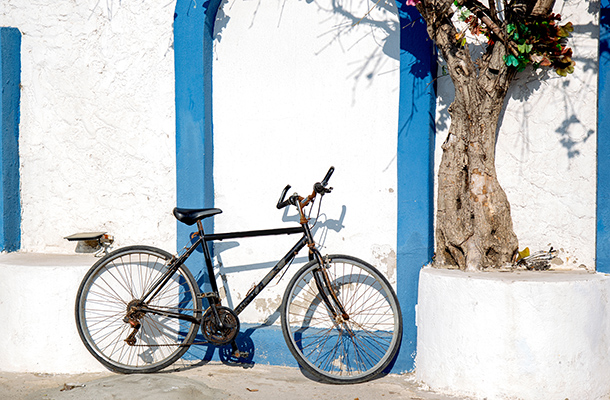 Bicycle outside whitewashed building in Greece